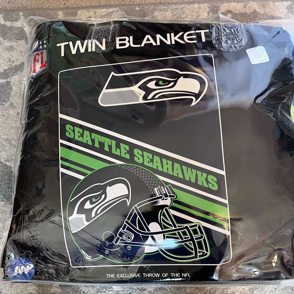 Brand new Seattle Seahawks twin size fleece blanket. Still in original package.
